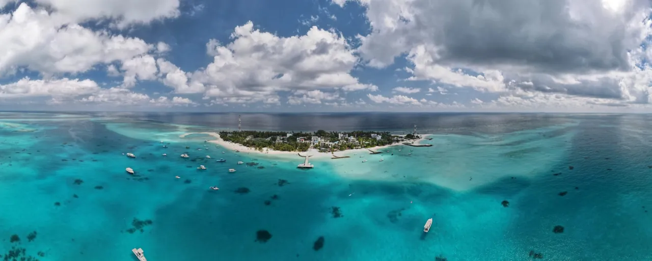 Aerial view of Fulidhoo local island with boats in the lagoon