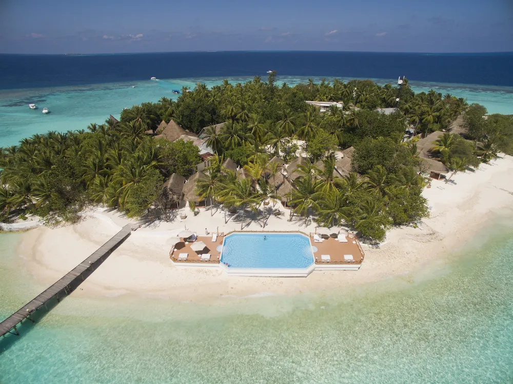 Palm-covered Thulhagiri island with a beach and pool