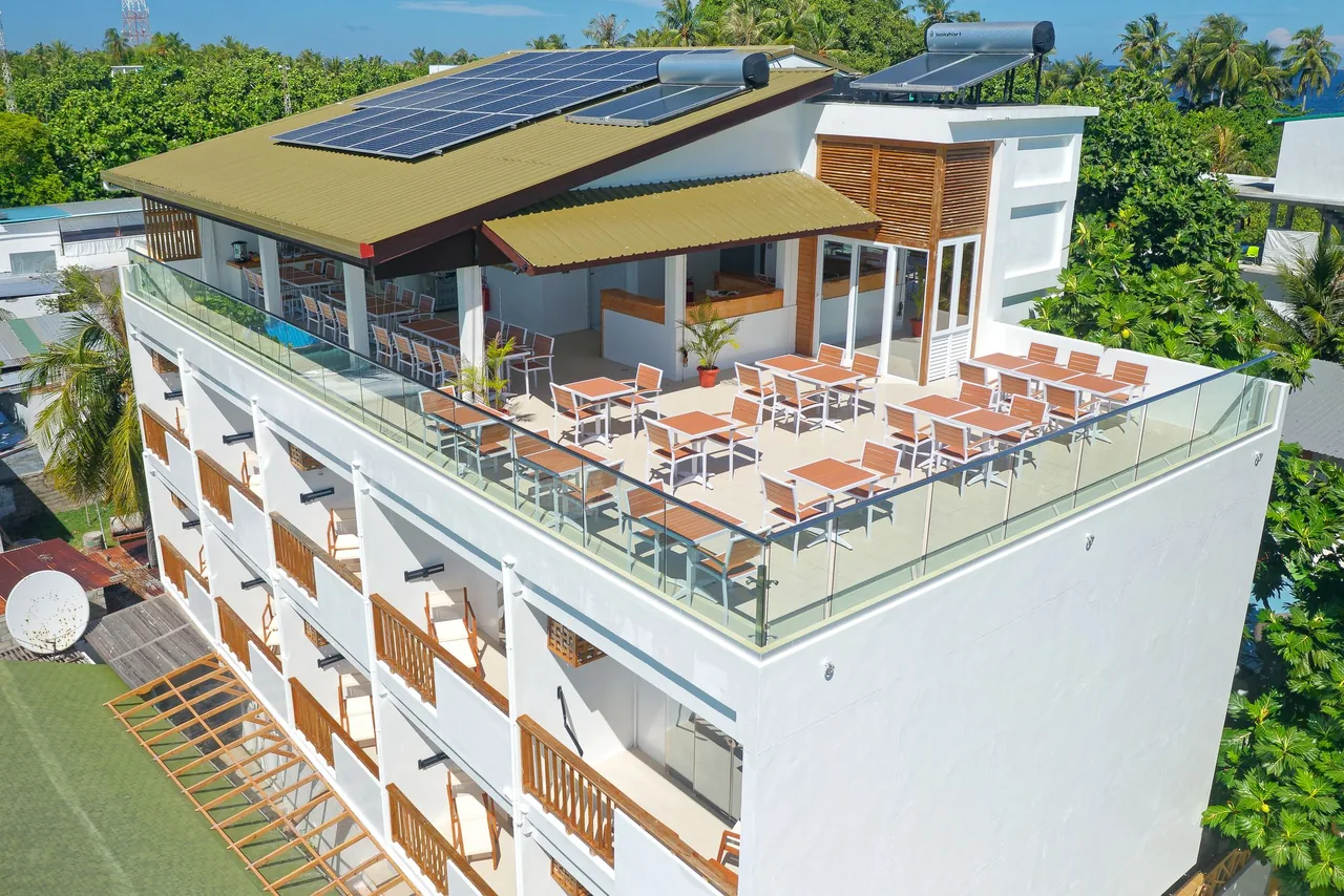 Aerial view of Luau Beach Inn and its rooftop restaurant terrace