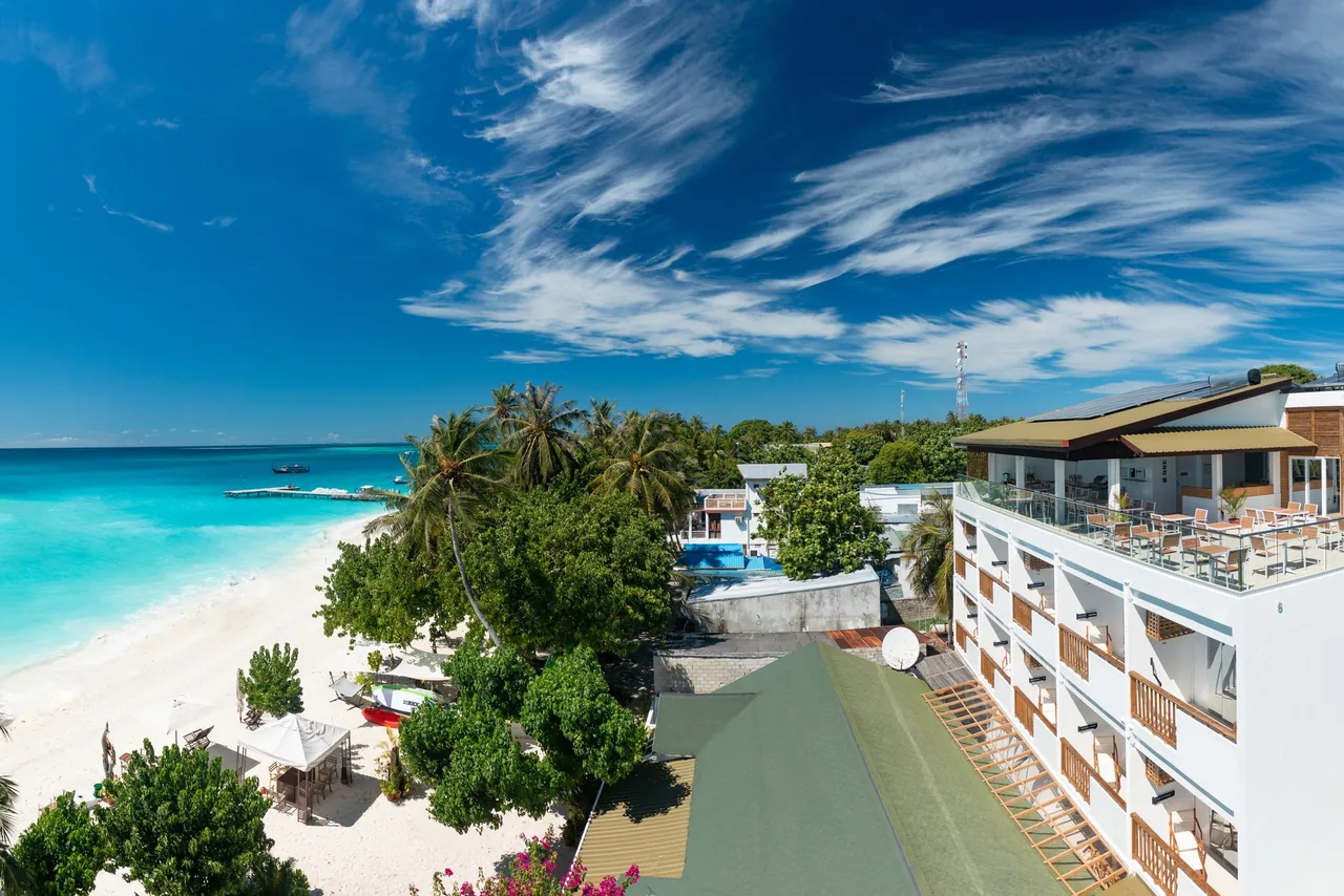 Luau Beach Inn beside the white-sand beach and turquoise lagoon on Fulidhoo, Maldives