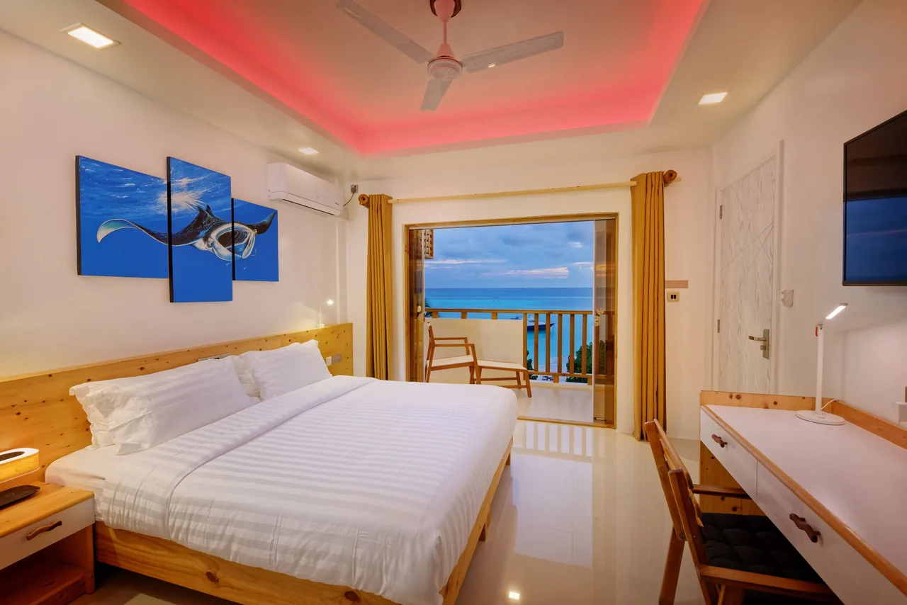 Deluxe Seaview room with a balcony looking onto the sea at Luau Beach Inn