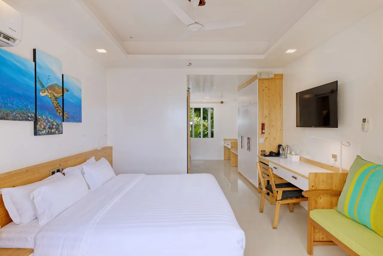 Superior Deluxe Seaview room with a king bed and desk at Luau Beach Inn