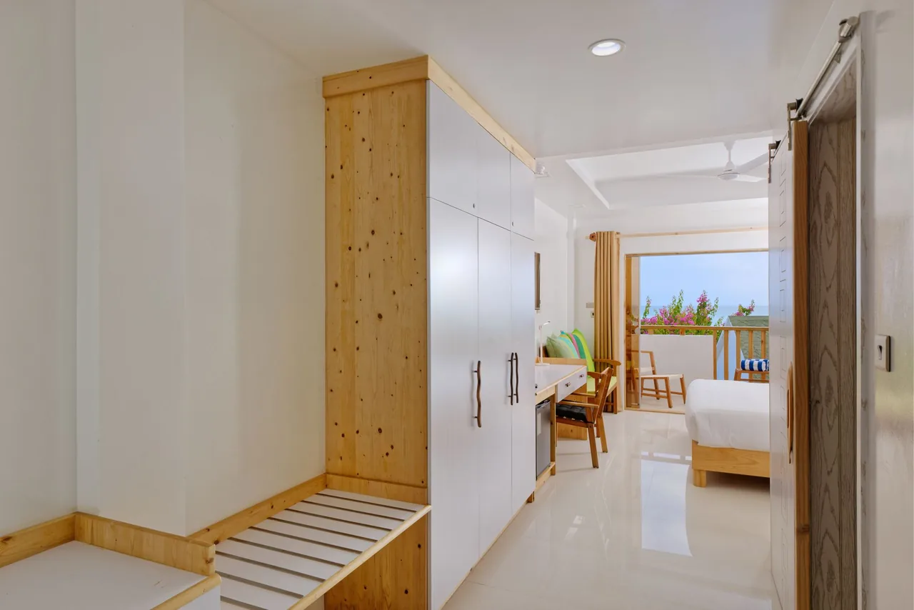 Superior Deluxe Seaview room with wardrobe and balcony view at Luau Beach Inn