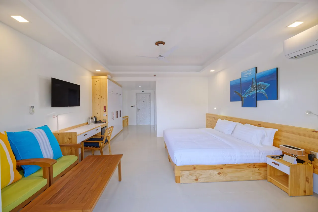 Family room seating area and beds at Luau Beach Inn