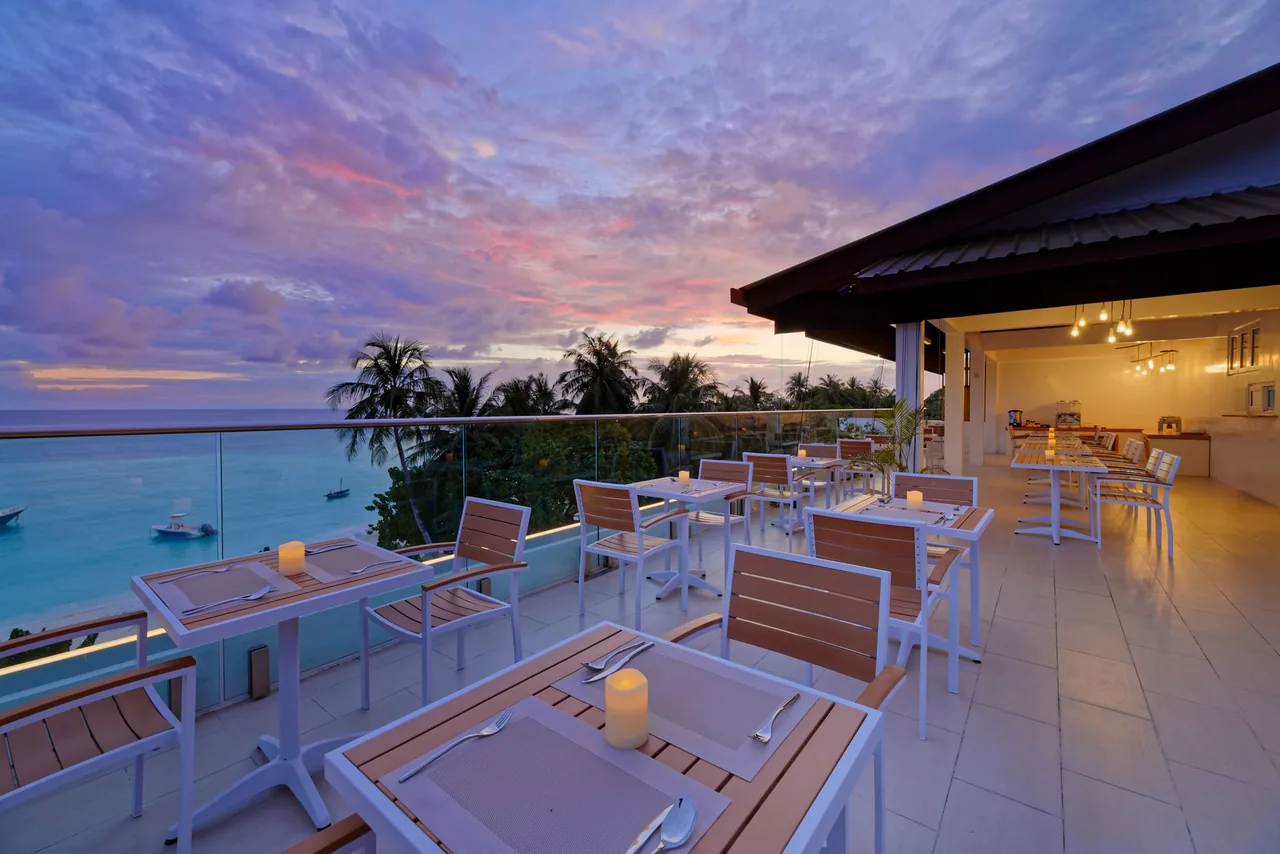 Luau Restaurant rooftop terrace at sunset with views of the ocean