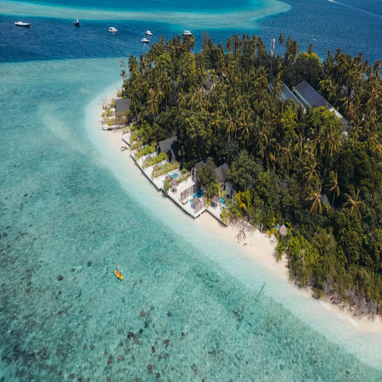 Aerial view of Malahini Kuda Bandos resort, its beach and villas in the Maldives