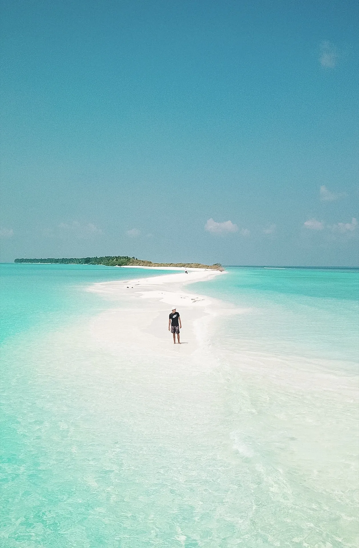 A narrow white sandbank at Dhigurah with turquoise water on both sides